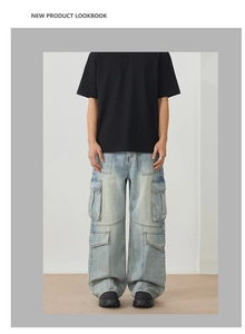 Detail of light blue multi-pocket cargo jeans with washed vintage texture and flap pockets