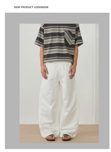 Minimalist white wide-leg casual pants paired with a grey striped t-shirt lookbook style