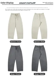Detail of high-waist straight-leg trousers in apricot and grey colors with belts