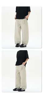 Close-up of beige wide-leg trousers featuring a diagonal twill texture and matching belt