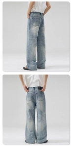 Detail of vintage washed light blue denim jeans with back leather patch and wide leg fit