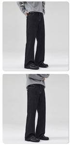 Detail of dark blue wide-leg jeans with orange contrast stitching and retro silhouette
