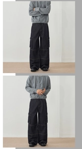 Detail view of retro wide leg denim cargo pants with side pockets and contrast stitching
