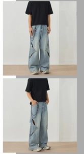 Detail of light blue wide-leg jeans with star cut-outs and a detachable silver waist chain