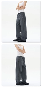 Detail view of heavy washed dark grey wide-leg jeans with matching fabric belt