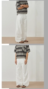 Detail of white wide-leg cotton pants paired with retro striped t-shirt and flip-flops
