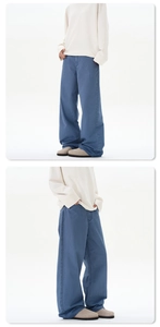 Detail view of loose straight wide-leg denim jeans in vintage stone wash blue