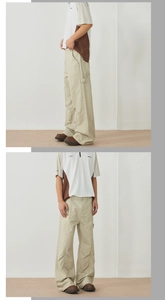 Detail view of khaki wide-leg cargo pants featuring side pocket design and relaxed fit