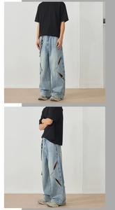Detail of star-shaped cut-outs on light blue loose-fit streetwear denim jeans