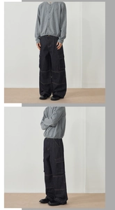 Detail view of American vintage loose fit cargo denim pants with side utility pockets
