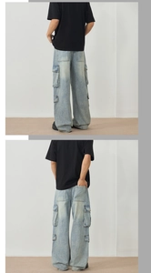 Detail of light blue washed cargo jeans with side flap pockets and relaxed straight fit