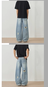 Detail of light blue wide-leg jeans featuring distressed hollow-out back design