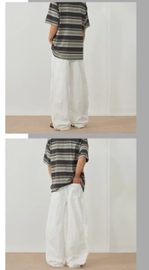 Detail view of baggy white casual trousers with wide-leg silhouette and premium cotton fabric