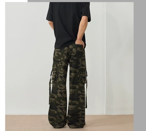 Rear view of camouflage cargo pants featuring oversized side pockets and hanging straps