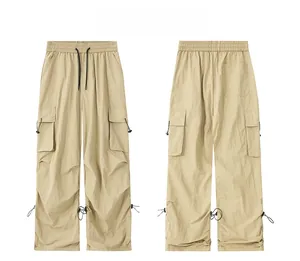 Detail display of khaki cargo pants featuring elastic waist and adjustable drawstring cuffs