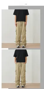 Detail of cargo pants showing elastic drawstring waist and adjustable hem design