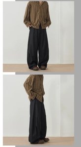 Detailed view of striped long sleeve shirt and wide leg trousers on a model