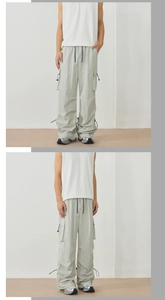 Macro detail of light grey cargo pants with adjustable drawcord hem and side pockets