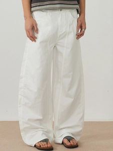 Minimalist white wide-leg cotton trousers for men and women with relaxed straight-cut design