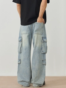 Men's light blue oversized cargo jeans with multi-pocket design and washed denim finish