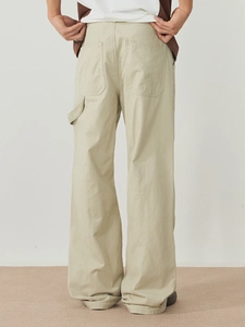 Rear view of men's loose beige cotton cargo pants with large back pockets and utility loop