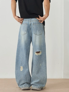 Men's baggy street style light blue washed jeans with distressed rip details from the back