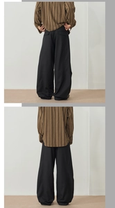 Rear view of black oversized trousers with premium drape and back pocket detail