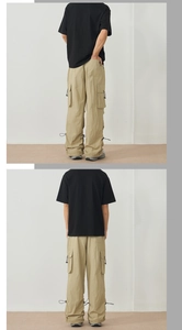 Detail of khaki outdoor cargo pants featuring large side pockets and adjustable hem drawstrings