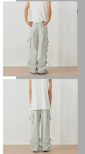Detail of light green quick-dry cargo pants with large flap pockets and adjustable hem
