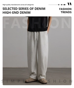Close-up of light gray athletic sweatpants featuring drawstring waist and premium fabric texture