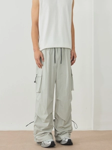 Unisex loose-fit outdoor cargo pants in light green with adjustable drawstring waist