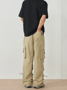 Men's khaki cargo pants with side pockets and adjustable drawstring hem in street style