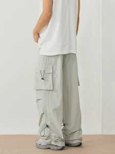 Sage green quick-dry tactical cargo pants with drawstring hem in a loose fit style