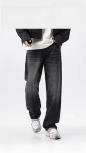 Detail of vintage washed grey loose fit jeans with distinctive whiskering on the denim fabric