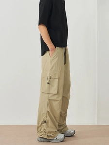 Men's khaki stretch cargo pants with side flap pockets and adjustable black drawstrings