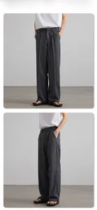 Detail view of deep gray pleated wide-leg trousers featuring clean fit minimalist style