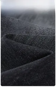 Detail of soft breathable black denim fabric with vintage texture and smooth drape