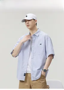 Close-up of a men's light blue striped short-sleeved shirt with a classic front pocket