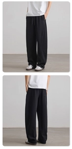 Close-up of black wide-leg joggers with drawstring waist and rear patch pocket detail