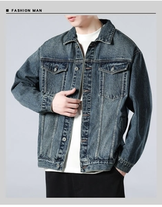 Detail of vintage washed denim jacket showing chest pockets and classic metal buttons