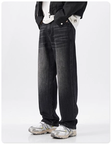 Detail of vintage washed denim texture and whisker effect on grey wide leg jeans