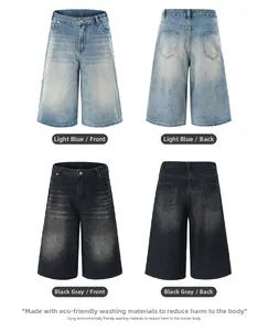 Detail of loose-fit denim shorts in light blue and grey with whiskers and five-pocket design