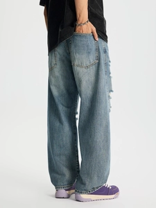 Jeans a gamba larga celeste con dettagli frangiati laterali ed effetto lavaggio vintage