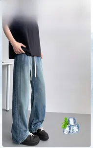 Detail of light blue wide-leg jeans featuring side seams and a white drawstring waist