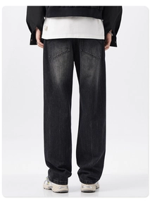 Rear view of men's vintage washed grey wide leg denim jeans with back pockets