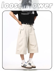 Detail of loose fit cargo shorts in off-white heavy cotton with large utility side pockets