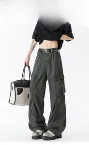 Detailed side view showing multiple 3D cargo pockets on loose retro dark grey jeans