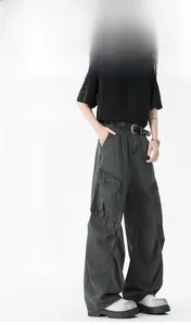 Close-up of dark grey wide-leg cargo pants featuring large side pockets and cotton twill