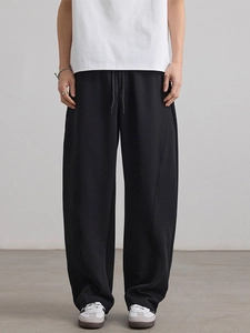 Men's loose black straight-leg sweatpants with drawstring waist and vertical seam detailing