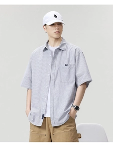 Detailed view of striped short sleeve shirt fabric texture with chest pocket